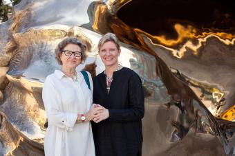 Jill Wilkinson and Andrée Bober in front of a sculpture