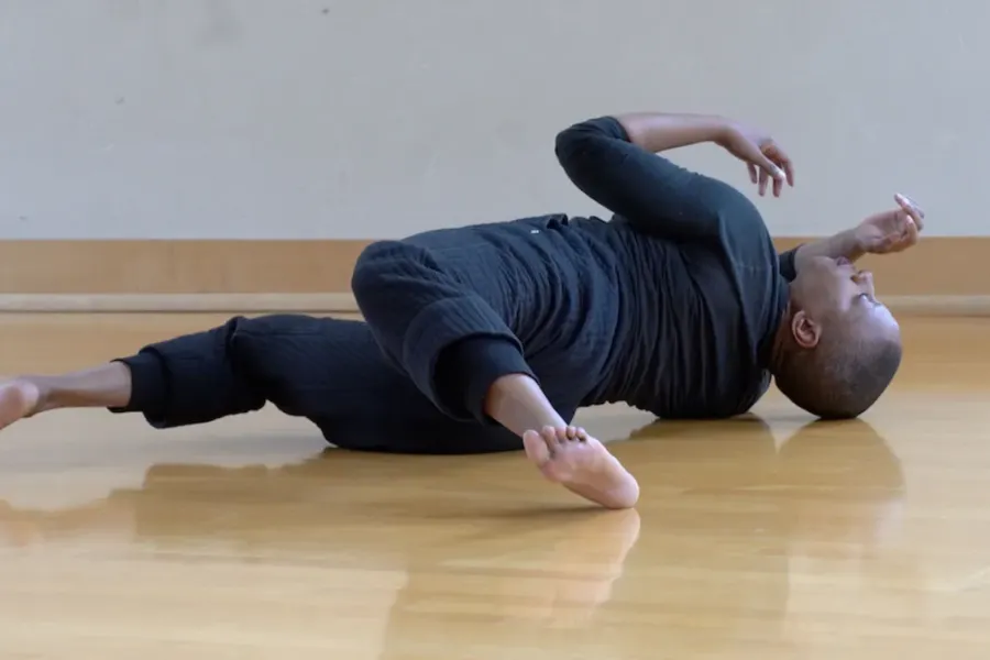 person laying on floor in twisted position